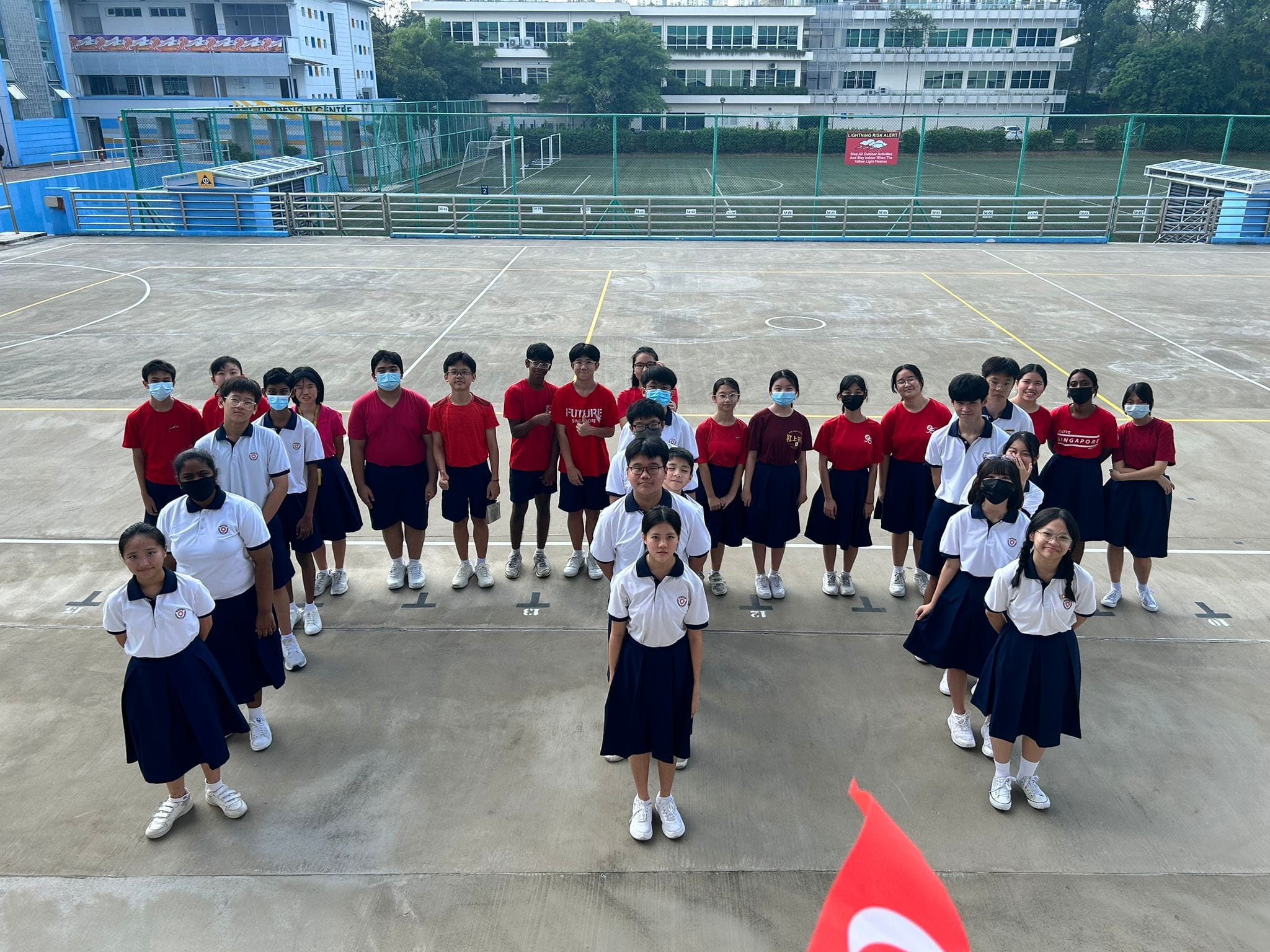 Students assembled at the parade grounds, standing in the shape of the marina bay sands